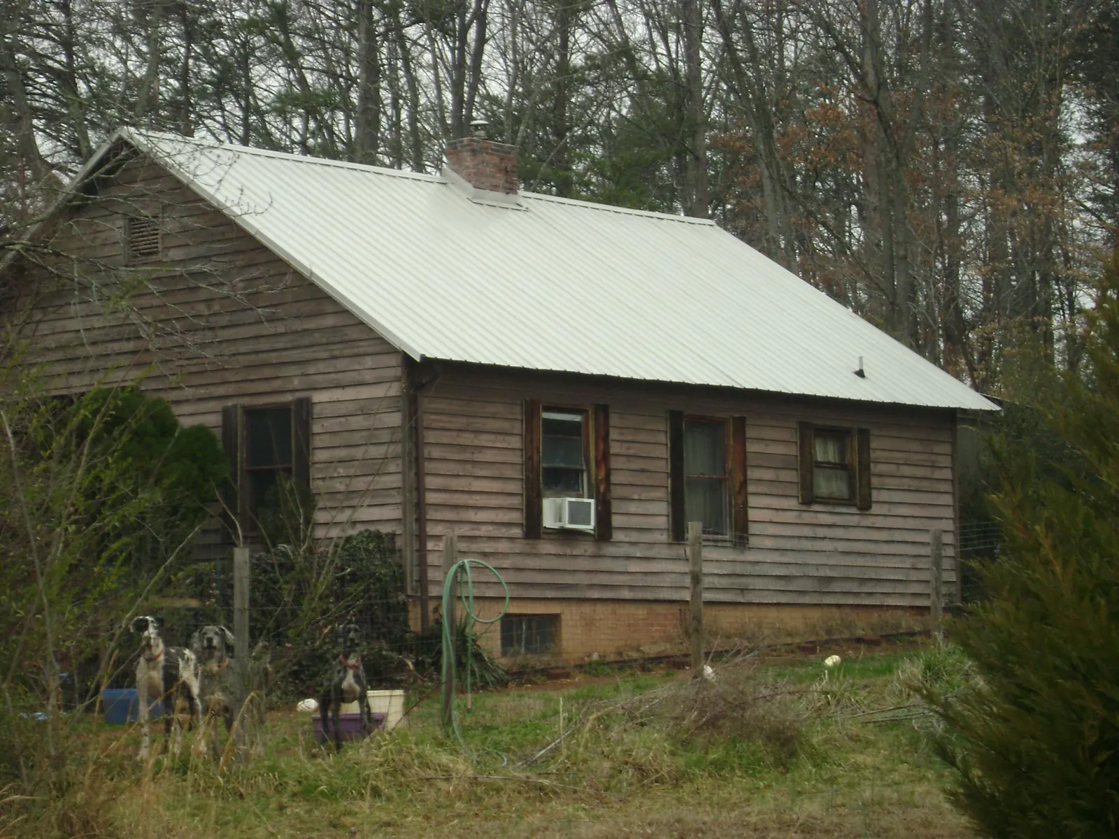 White metal roof on an old wood sided farmhouse, from a Asphalt Shingle Roof Repair job in Deer Creek